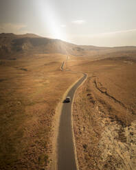 Aerial view of a car driving a road across the valley at Golden Gate Highlands National Park, South Africa. - AAEF18651