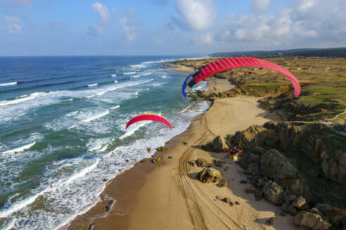 Aerial view of paramotor pilots flying along the Black Sea coast in Sahilkoy, Istanbul, Turkey. - AAEF18756