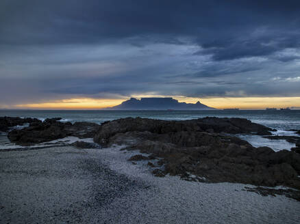 Aerial view of Table Mountain with moody sunrise from Bloubergstrand popular tourist travel destination, Cape Town, South Africa. - AAEF18859