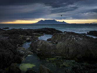Aerial view of Table Mountain with moody sunrise from Bloubergstrand popular tourist travel destination, Cape Town, South Africa. - AAEF18860