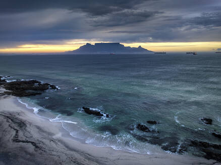 Aerial view of Table Mountain with moody sunrise from Bloubergstrand popular tourist travel destination, Cape Town, South Africa. - AAEF18861