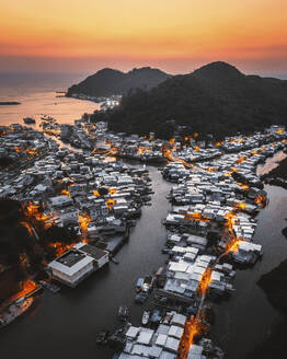 Aerial view of Hong Kong residential area along the Hong Kong island coastline at sunset, China. - AAEF18865