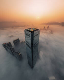 Aerial view of Hong Kong financial district at sunset with low clouds and fog, China. - AAEF18874