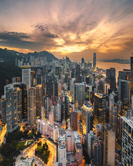 Aerial view of Hong Kong skyline at sunset along Hong Kong Island coastline, China. - AAEF18879