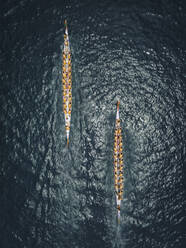 Aerial view of people paddling with long kayak for competition in Hong Kong bay, China. - AAEF18881