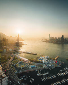 Aerial view of Hong Kong Yacht club along the bay waterfront with Hong Kong downtown skyline in background at sunset, China. - AAEF18888