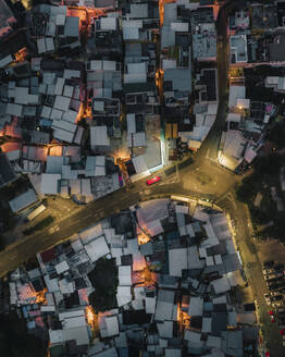 Aerial top down view of Shek O, a small settlement at night along the bay on Hong Kong island, China. - AAEF18892