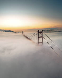 Aerial view of Tsing Ma Bridge at sunset with low clouds in Hong Kong Island, Hong Kong, China. - AAEF18909