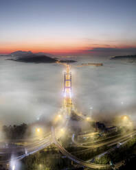 Aerial view of Tsing Ma Bridge at sunset with low clouds in Hong Kong Island, Hong Kong, China. - AAEF18910