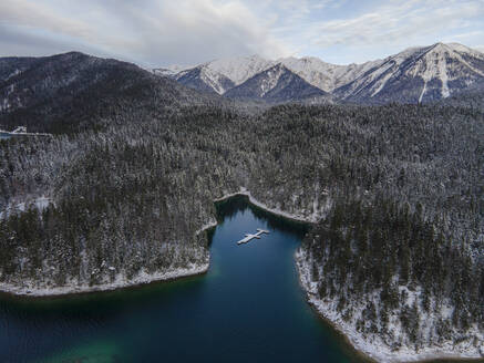 Aerial view of snowy forest at the lake Eibsee in Bavaria, Germany. - AAEF18951