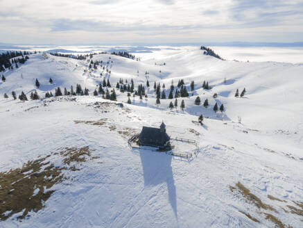 Aerial view of a chapel in Velika Planina, Slovenia. - AAEF18960