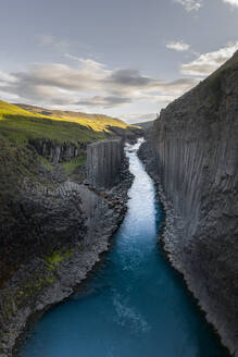 Aerial Drone View of the Studlagil Canyon with its basalt columns, Egilsstadir, Iceland. - AAEF19009