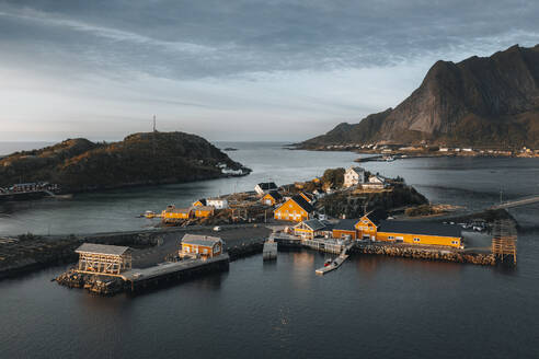 Aerial drone view of the yellow fisherman houses of Sakrisoy, Lofoten, Norway. - AAEF19018