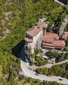 Aerial view of Holy Monastery of Rousanos on a natural pillar rock formation in Meteora, Trikala, Thessaly, Greece. - AAEF19042