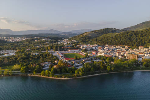 Aerial view Igoumenitsa Municipal stadium along the bay at sunset, Epirus, Greece. - AAEF19109