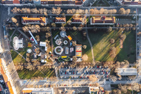 Aerial view of a theme park with Ferris wheel at Trg Franje Tudjmana park at sunset in Zagreb downtown, Croatia. - AAEF19156