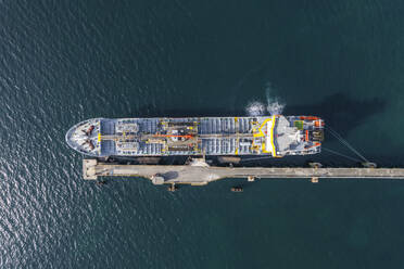 Aerial view of a cargo ship along the pier in Scarlino, Grosseto, Tuscany, Italy. - AAEF19197