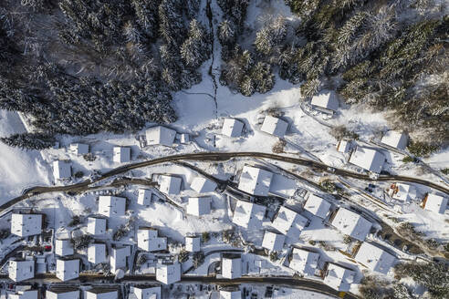 Aerial view of a residential area with houses covered with snow in wintertime, Champery, Valais, Switzerland. - AAEF19202