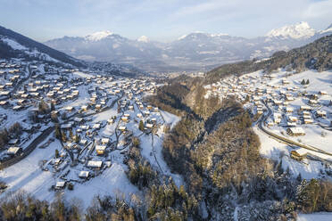 Aerial view of Troistorrents, a small town on the Alps in wintertime with snow, Valais, Switzerland. - AAEF19204