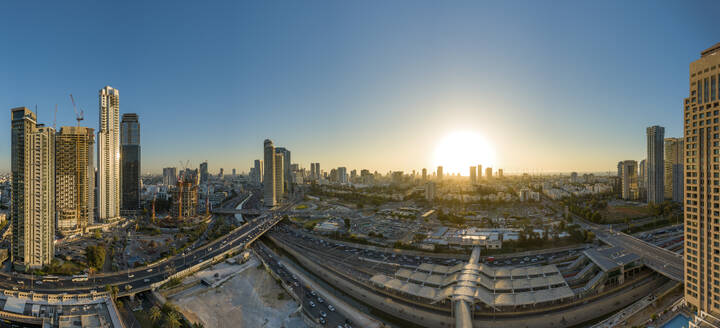 Panoramic aerial view of a highway in a city with traffic jam at sunset, Tel Aviv, center district, Israel. - AAEF19217