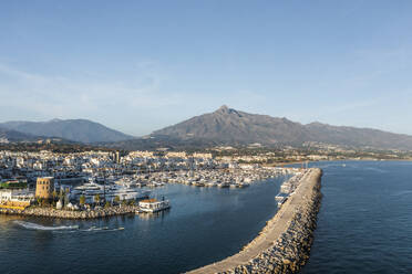 Aerial view of Puerto Banus, a small city harbour with boats and yacht moored, Marbella, Andalusia, Spain. - AAEF19249