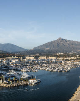 Aerial view of Puerto Banus, a small city harbour with boats and yacht moored, Marbella, Andalusia, Spain. - AAEF19250