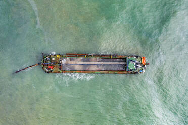 Aerial view of a container ship along the Mediterranean Sea coast in Fuengirola, Malaga, Spain. - AAEF19257