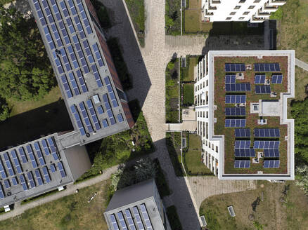 Aerial view of solar panels and roof greening measures in a housing estate in Berlin, Germany. - AAEF19292