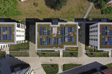 Aerial view of solar panels and roof greening measures in a housing estate in Berlin, Germany. - AAEF19294