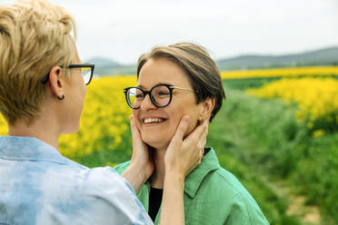 Glückliches lesbisches Paar mit Brillen, das sich umarmt - VSNF00964