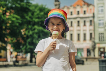 Happy girl holding ice cream at sunny day - VSNF00994