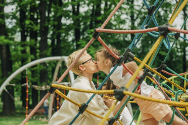 Mutter küsst Tochter auf dem Spielplatz - VSNF01012