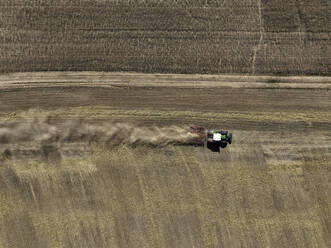 Aerial view of cereal harvesters and tractors at a farm in Oderbruch, Brandenburg, Germany. - AAEF19348