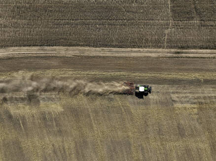 Aerial view of cereal harvesters and tractors at a farm in Oderbruch, Brandenburg, Germany. - AAEF19348