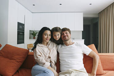 Father and mother with daughter in living room at home - SYEF00438