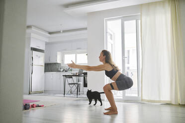 Young woman stretching and doing exercise at home - ANNF00305