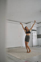 Happy young woman dancing and having fun at home - ANNF00319