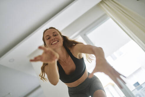 Happy young woman enjoying and dancing at home - ANNF00321