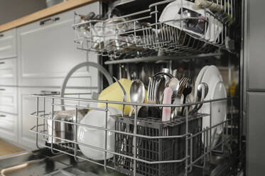 Clean dishes and cutlery inside dishwasher - ALKF00335