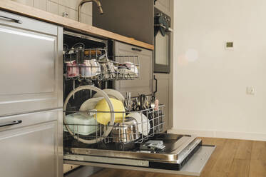 Clean dishes inside dishwasher in beautiful kitchen - ALKF00338