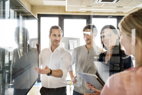 Businessman with colleagues having discussion in office - PESF03948