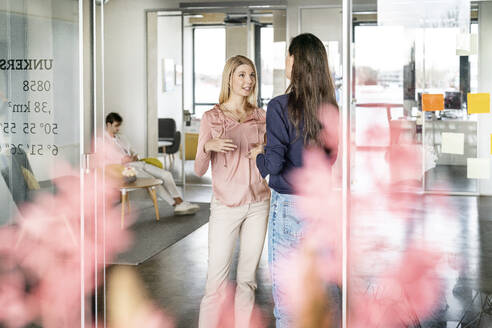 Businesswoman having discussion with colleague in office - PESF03960
