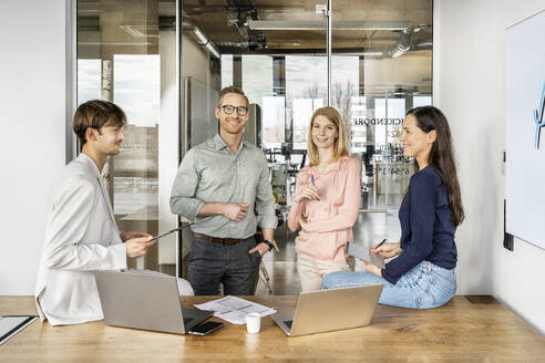 Happy colleagues working and having discussion together - PESF03967