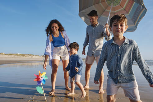 Happy family enjoying at beach - ASGF03821