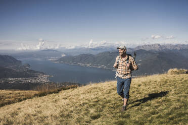 Smiling man hiking on mountain - UUF28887