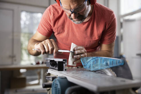 Carpenter working on wood with tool in workshop - CVF02430