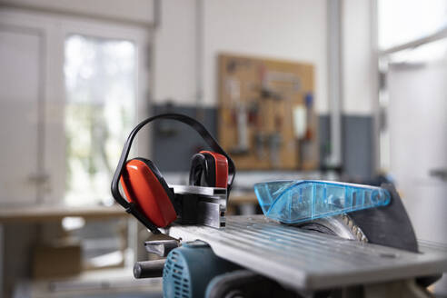 Circular saw and ear protectors in workshop - CVF02432