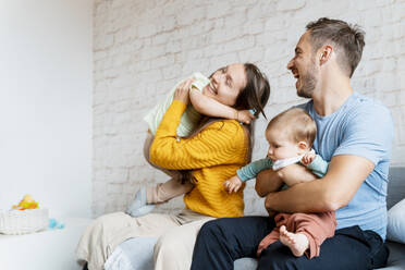 Happy family spending leisure time in living room - NDEF00752