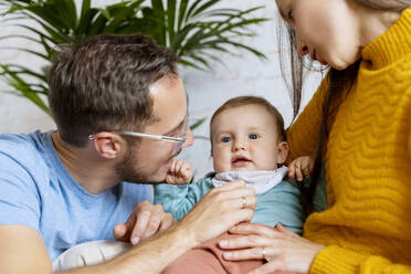 Happy parents playing with baby boy at home - NDEF00755