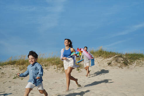 Happy family together running at beach - ASGF03861